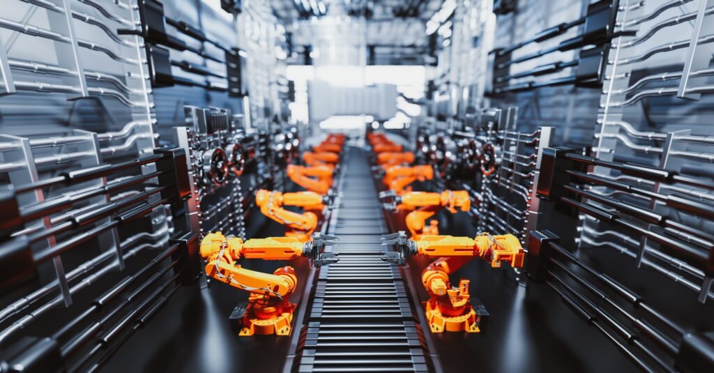 Robotic arms along assembly line in modern factory.